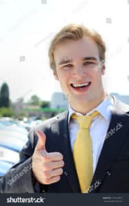 stock photo cheesy professional business man car salesman at car sales lot arms crossed looking at camera 175143962